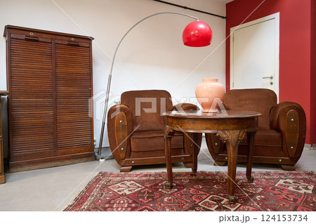 Loft with old fashionned table and sofa against white wall 124153734