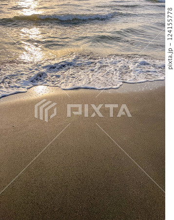 Black Sea waves and sandy beach with water during sunset or sunrise. 124155778
