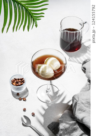 Affogato coffee with vanilla ice cream scoops and espresso in a tall glass on a white background Affogato coffee with vanilla ice cream scoops and espresso in a tall glass on a white background 124155792