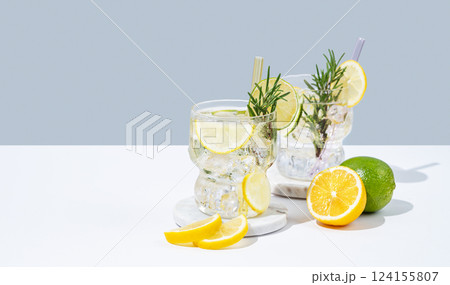 Two glasses fresh lemonade with lemon, lime, rosemary and ice. Citrus cocktail mojito Two glasses fresh lemonade with lemon, lime, rosemary and ice. Citrus cocktail mojito 124155807