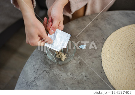 Woman preparing a homemade cosmetic clay mask Woman preparing a homemade cosmetic clay mask 124157403