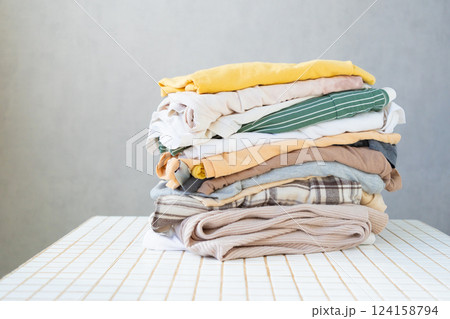 mockup, a stack of clean clothes on the table. dry cleaning. Housecleaning, housewife. mockup, a stack of clean clothes on the table. dry cleaning. Housecleaning, housewife. 124158794