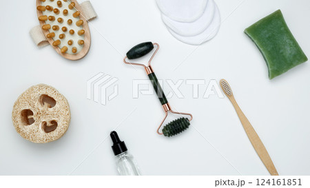 Embodying a sustainable self-care concept, eco-friendly beauty essentials, including soap, bamboo toothbrush, loofah sponge, marble face roller Embodying a sustainable self-care concept, eco-friendly beauty essentials, including soap, bamboo toothbrush, loofah sponge, marble face roller 124161851