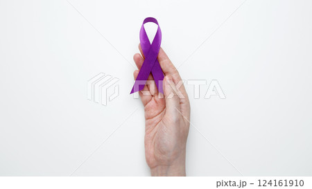 Purple ribbon held, symbol of support. Purple Epilepsy Awareness Day Purple ribbon held, symbol of support. Purple Epilepsy Awareness Day 124161910