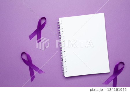 Purple Epilepsy Awareness Day, purple ribbon held, symbol of support. Mock up notebook 124161953