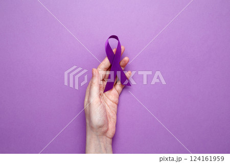 Purple Epilepsy Awareness Day, purple ribbon held, symbol of support 124161959