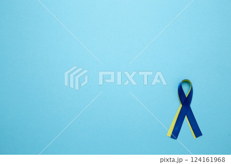 A yellow and blue awareness ribbon, symbolizing World Down Syndrome Day A yellow and blue awareness ribbon, symbolizing World Down Syndrome Day 124161968