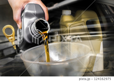 Oil change process in automotive service garage , Double exposure , The mechanic poured engine oil into a funnel on the engine oil fill port , Car maintenance concept Oil change process in automotive service garage , Double exposure , The mechanic poured engine oil into a funnel on the engine oil fill port , Car maintenance concept 124162975