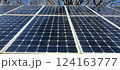 Solar panels are installed in a natural setting, showcasing the technology designed to harness solar energy under a bright blue sky on a sunny day 124163777