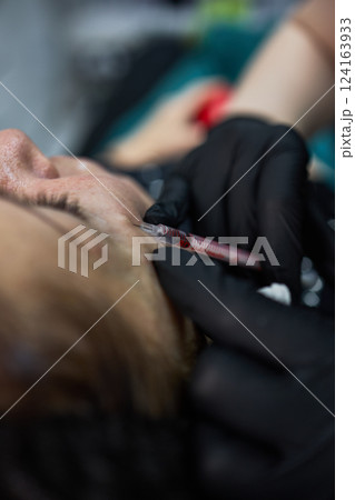 Closeup of Cosmetic Facial Injection with Black Gloves and Syringe, Focus on Safety and Precision, Anti-Aging Beauty Treatment Concept Closeup of Cosmetic Facial Injection with Black Gloves and Syringe, Focus on Safety and Precision, Anti-Aging Beauty Treatment Concept 124163933