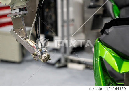 Close up scene the automatic painting robot working with automotive parts. Close up scene the automatic painting robot working with automotive parts. 124164120
