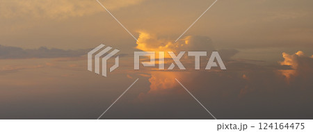 Dramatic sunset sky covered with colorful yellow clouds. Panoramic skyscape 124164475