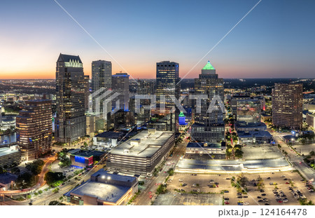 Downtown of Tampa in Florida, USA. Car traffic on city streets and brightly illuminated high skyscraper buildings. American travel destination. 124164478