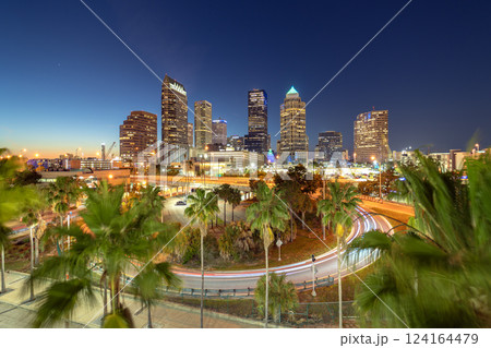 Downtown district of Tampa city in Florida, USA after sunset. Brightly illuminated highway and high buildings in modern American urban area. 124164479