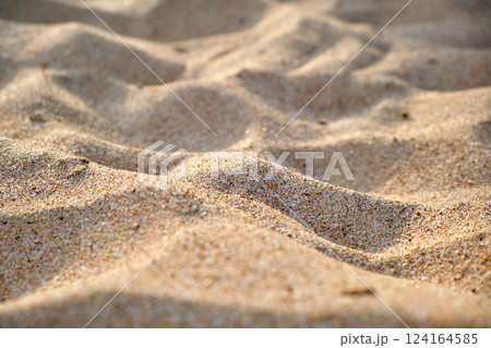 Close up of clean yellow sand surface covering seaside beach illuminated with day light. Travel and vacations concept Close up of clean yellow sand surface covering seaside beach illuminated with day light. Travel and vacations concept 124164585