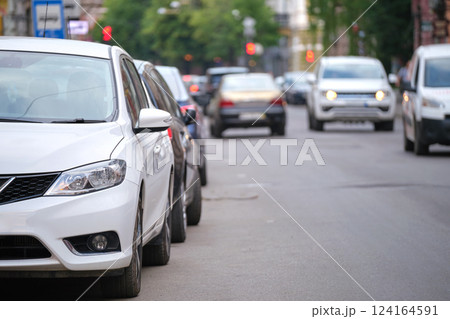 City traffic with cars parked in line on street side City traffic with cars parked in line on street side 124164591