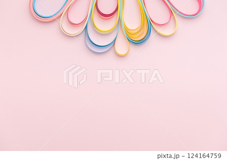 Paper strip curls on pink background 124164759