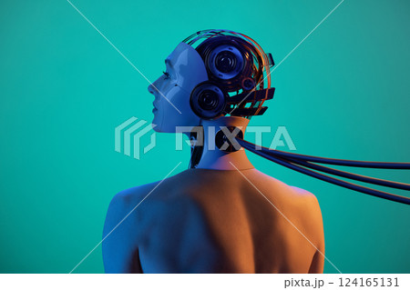 Handmade collage made of woman's portrait and 3D model of robot cyborg head connected with cables against green background in orange-blue lighting. 124165131