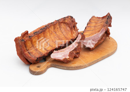Delicious Smoked Pork Ribs Presented on a Wooden Cutting Board 124165747
