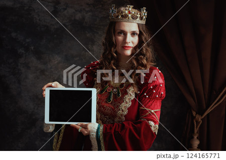 medieval queen in red dress showing tablet PC blank screen medieval queen in red dress showing tablet PC blank screen 124165771