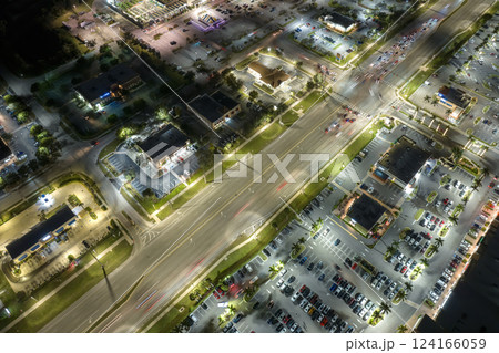 Aerial view of shopping plaza stores and American wide highway with many driving cars in North Port, Florida Aerial view of shopping plaza stores and American wide highway with many driving cars in North Port, Florida 124166059