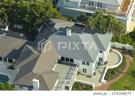 Aerial view of new american home roof with blue solar photovoltaic panels for producing clean ecological electric energy. Renewable electricity with zero emission concept 124166075