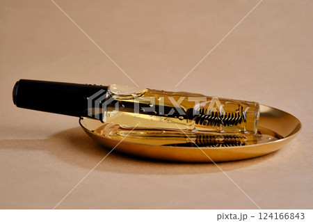 Bottle with brush filled with oil for eyebrow and eyelash growth. Texture. 124166843