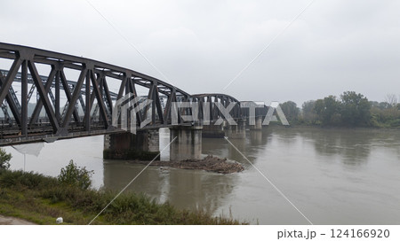 Old railway bridge crossing the po river in cremona italy Old railway bridge crossing the po river in cremona italy 124166920