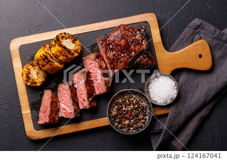 A perfectly cooked sliced striploin steak with a juicy, tender texture A perfectly cooked sliced striploin steak with a juicy, tender texture 124167041
