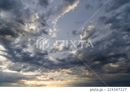 A dramatic and moody sky filled with dark, swirling clouds A dramatic and moody sky filled with dark, swirling clouds 124167127