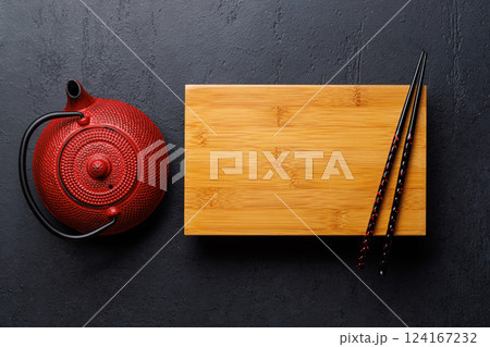 Japanese Table Setting with Wooden Board, Teapot, Chopsticks Japanese Table Setting with Wooden Board, Teapot, Chopsticks 124167232