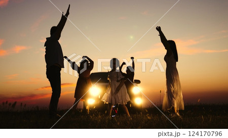 Family party in nature by car, children kids parents dancing together enjoying summer time fun company. Kids sons daughters mom dad having good time with music by car big family travelling road trip 124170796