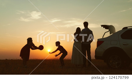 Family at sunset by car in field silhouettes. Children kids plays ball parents hugging enjoying romantic atmosphere happy moment. Importance of Spending Time Together Creating Lasting Family Memories 124170799