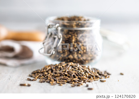 Milk thistle seeds on kitchen table. 124170820