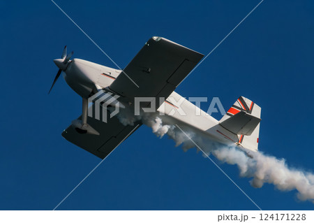 Stunt aerobatic plane performing stunts in air 124171228