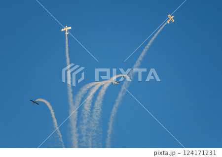 Stunt aerobatic planes performing stunts in air Stunt aerobatic planes performing stunts in air 124171231