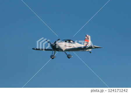 Stunt aerobatic plane performing stunts in air Stunt aerobatic plane performing stunts in air 124171242