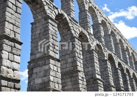 Tilted bottom view of Segovia Aqueduct, Roman construction for transporting water Tilted bottom view of Segovia Aqueduct, Roman construction for transporting water 124171703