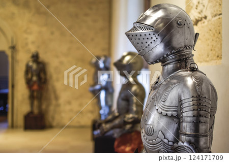 Close up side view of Medieval shiny Armor with details and armors in background 124171709