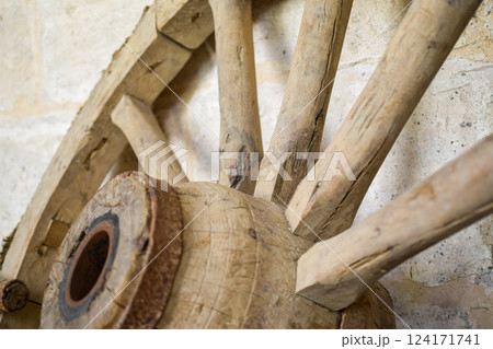 Antique wooden carriage wheel exposed on the street 124171741