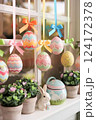 Easter Window Display: Hanging Eggs in Vibrant Colors and Satin Ribbons Easter Window Display: Hanging Eggs in Vibrant Colors and Satin Ribbons 124172378