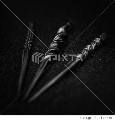 A Twisted Black Sculpture Set Against a Dark Background that Captivates the Viewer A Twisted Black Sculpture Set Against a Dark Background that Captivates the Viewer 124172716