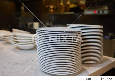 Beautifully Stacked Plates Arranged in a Contemporary Modern Kitchen Environment Setting Beautifully Stacked Plates Arranged in a Contemporary Modern Kitchen Environment Setting 124172772