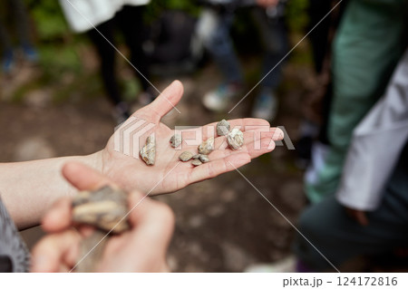Hands Holding Unique Natural Stones in a Beautiful Outdoor Setting Surrounded by Nature 124172816