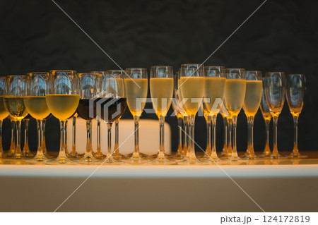 lot of glasses with champagne during on the party table lot of glasses with champagne during on the party table 124172819
