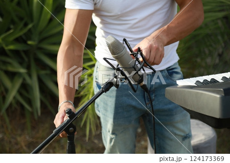 Musician Arranges His Keyboard For The Evening Performance In A Park Musician Arranges His Keyboard For The Evening Performance In A Park 124173369
