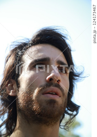 Italian Man with Long Hair Breathes Concentrated Pure Air in the Mountains Italian Man with Long Hair Breathes Concentrated Pure Air in the Mountains 124173467