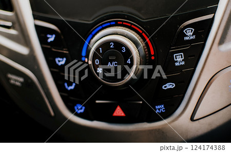 Front view of a car air conditioning control panel. Air conditioning knob of a car. Close up of automotive air conditioning switch panel Front view of a car air conditioning control panel. Air conditioning knob of a car. Close up of automotive air conditioning switch panel 124174388