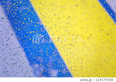 Gotas de lluvia con fondo de bandera de ucrania, gotas de lluvia sobre vidrio con colores de bandera de ucrania. Gotas de agua en la ventana sobre fondo de vidrio Gotas de lluvia con fondo de bandera de ucrania, gotas de lluvia sobre vidrio con colores de bandera de ucrania. Gotas de agua en la ventana sobre fondo de vidrio 124175598