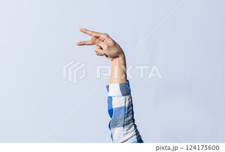 Hand gesturing the letter P in sign language on an isolated background. Man's hand gesturing the letter P of the alphabet isolated. Letter P of the alphabet in sign language 124175600